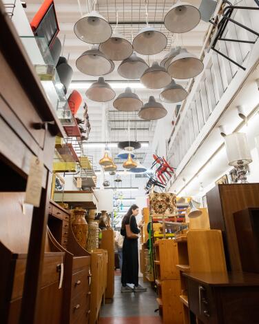 A woman shops for Midcentury Modern furnishings at Amsterdam Modern.