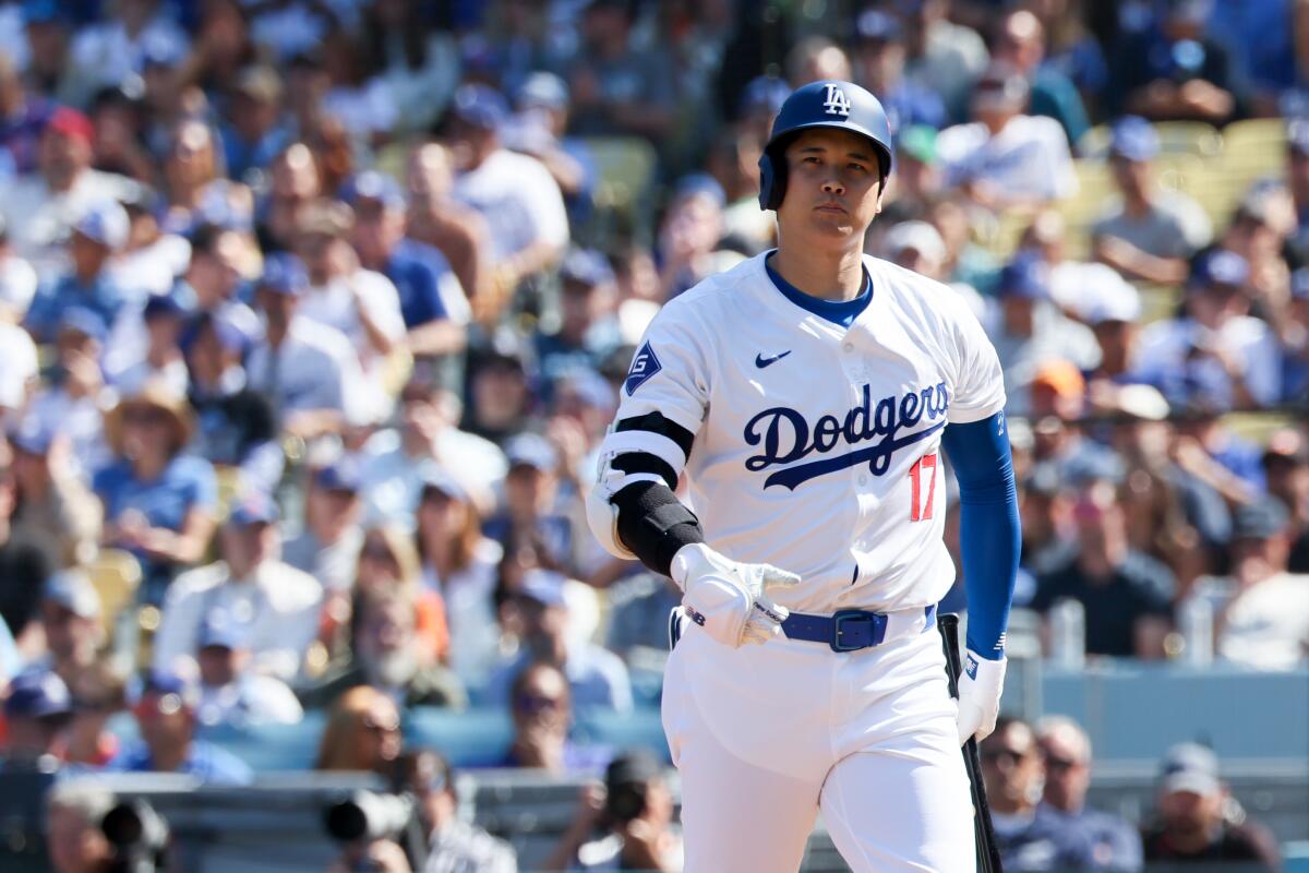 Dodgers star Shohei Ohtani walks back to the dugout after striking out in Game 2 of the NLCS.