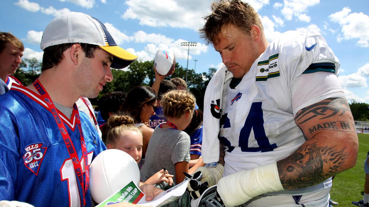 Buffalo Bills guard Richie Incognito (64) signs autographs at training camp in Pittsford, N.Y., on Aug. 2.