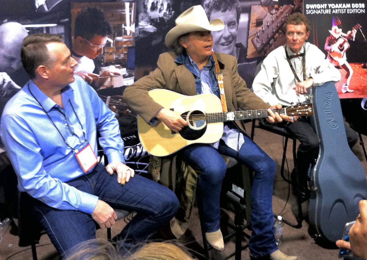 Dwight Yoakam, center, is flanked by Martin & Co. CEO Chris Martin IV, right, and Martin Custom Shop chief Jeff Allen on Thursday in Anaheim, where Martin's Dwight Yoakam signature guitar was introduced.