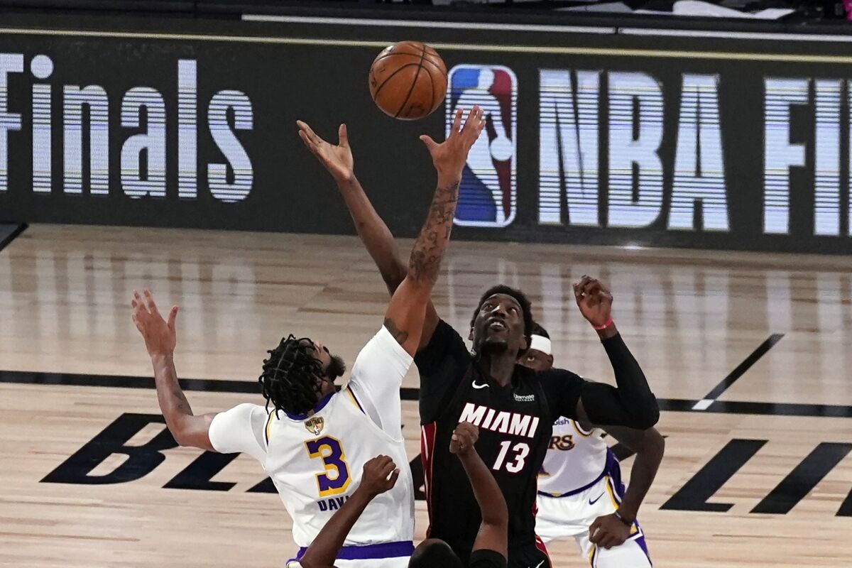Lakers forward Anthony Davis (3) and Miami Heat center Bam Adebayo (13) leap for the tipoff to start Game 6.