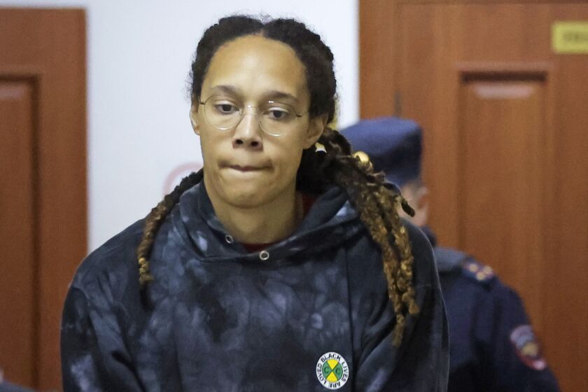 WNBA star and two-time Olympic gold medalist Brittney Griner is escorted to a courtroom for a hearing, in Khimki just outside Moscow, Russia, Monday, July 25, 2022. American basketball star Brittney Griner returns Tuesday to a Russian courtroom for her drawn-out trial on drug charges that could bring her 10 years in prison if convicted. (Evgenia Novozhenina/Pool Photo via AP)