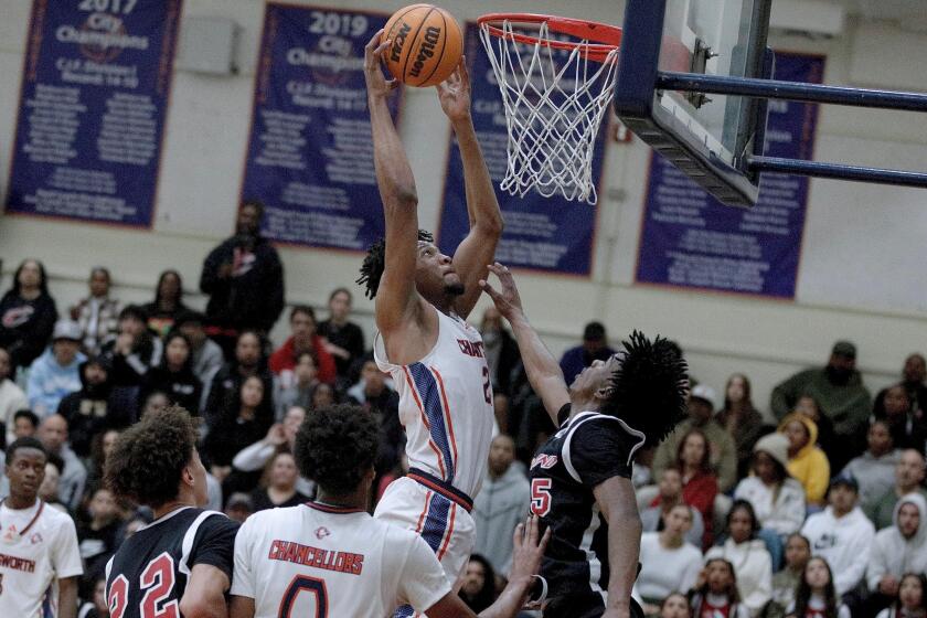 Chatsworth junior center Taj Unuakhalu grabs an offensive rebound in Tuesday night’s regional final against league rival Cleveland.