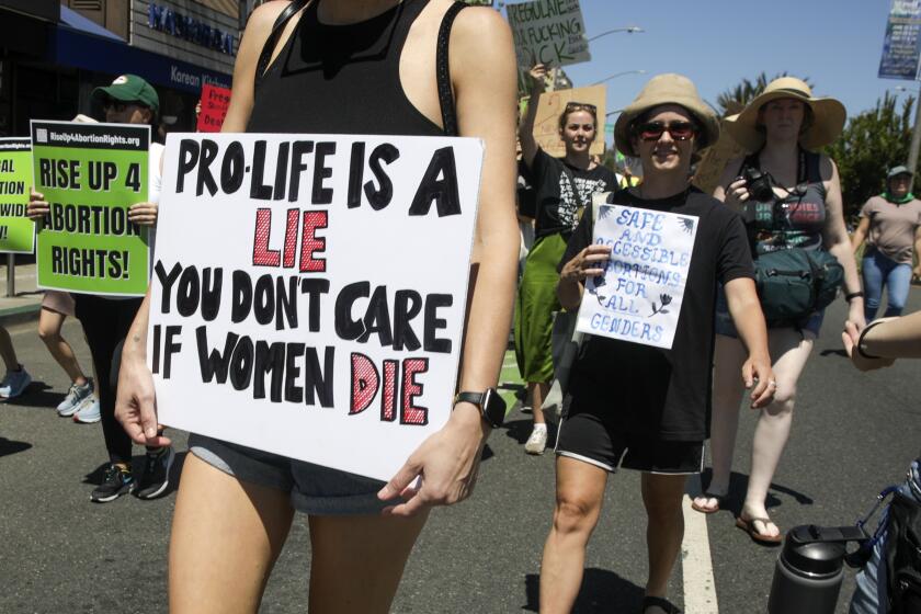 Long Beach, CA - July 02: Hundreds march in a rally organized by Abortion Safe House LBC, a coalition of volunteers providing abortion services and safe shelter for pregnant people, in support of nationwide protests by Rise Up 4 Abortion Rights, in the wake of the U.S. Supreme Court overturning Roe v. Wade, in Belmont Shore on Saturday, July 2, 2022 in Long Beach, CA. (Irfan Khan / Los Angeles Times)