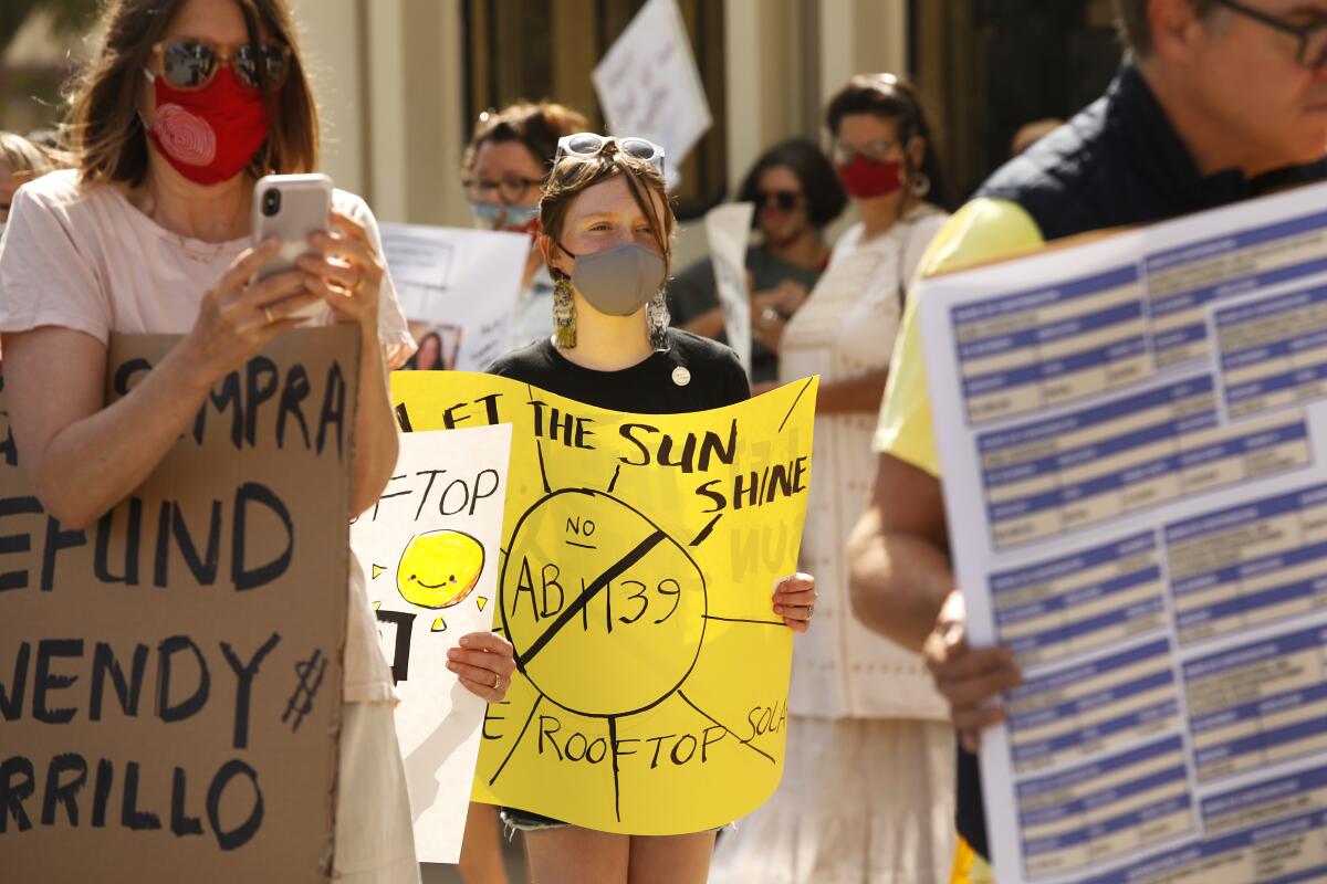 A girl is among those at a protest against Assembly Bill 1139.