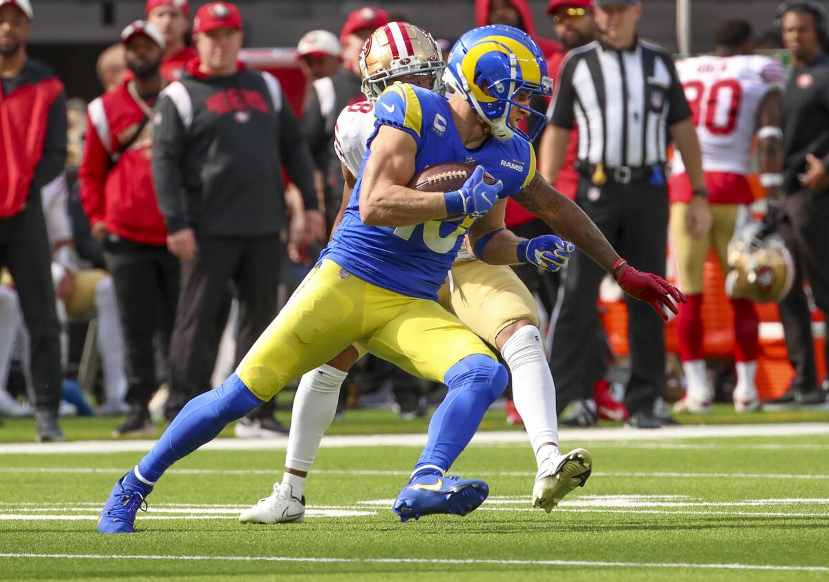 Rams wide receiver Cooper Kupp rushes as San Francisco 49ers defensive back Deommodore Lenoir tries to stop him.