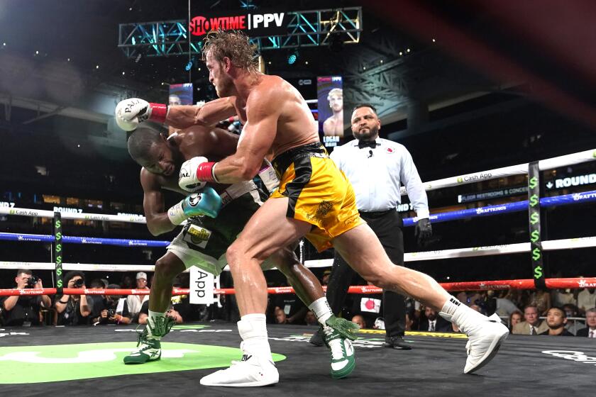 Floyd Mayweather, left, and Logan Paul fight during an exhibition boxing match at Hard Rock Stadium, Sunday, June 6, 2021, in Miami Gardens, Fla. (AP Photo/Lynne Sladky)