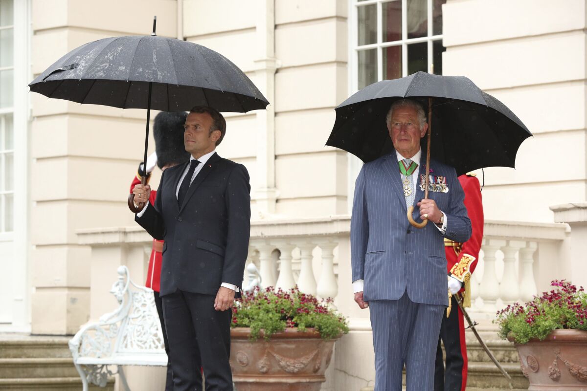 FILE - Britain's Prince Charles welcomes French president Emmanuel Macron, left, to Clarence House in London, Thursday June 18, 2020. French President Emmanuel Macron’s office on Friday, March 24, 2023, said a state visit by Britain’s King Charles III has been postponed amid mass strikes and protests in France. The king had been scheduled to arrive in France on Sunday on his first state visit as monarch, before heading to Germany on Wednesday. (Jonathan Brady/Pool via AP, File)