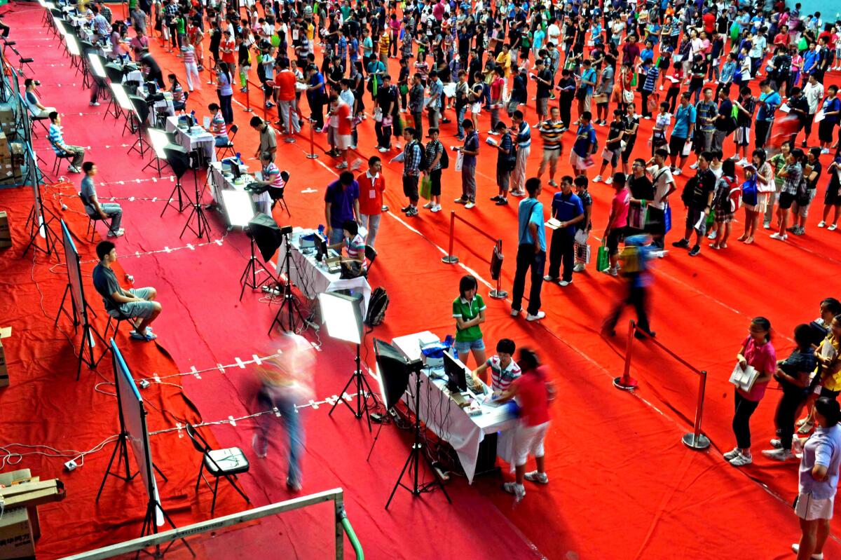 Freshmen students wait to register at Beijing's Tsinghua University. Beijing and to a lesser extent Shanghai were designated as China's intellectual centers, housing the top universities and the students deemed most deserving of higher education.