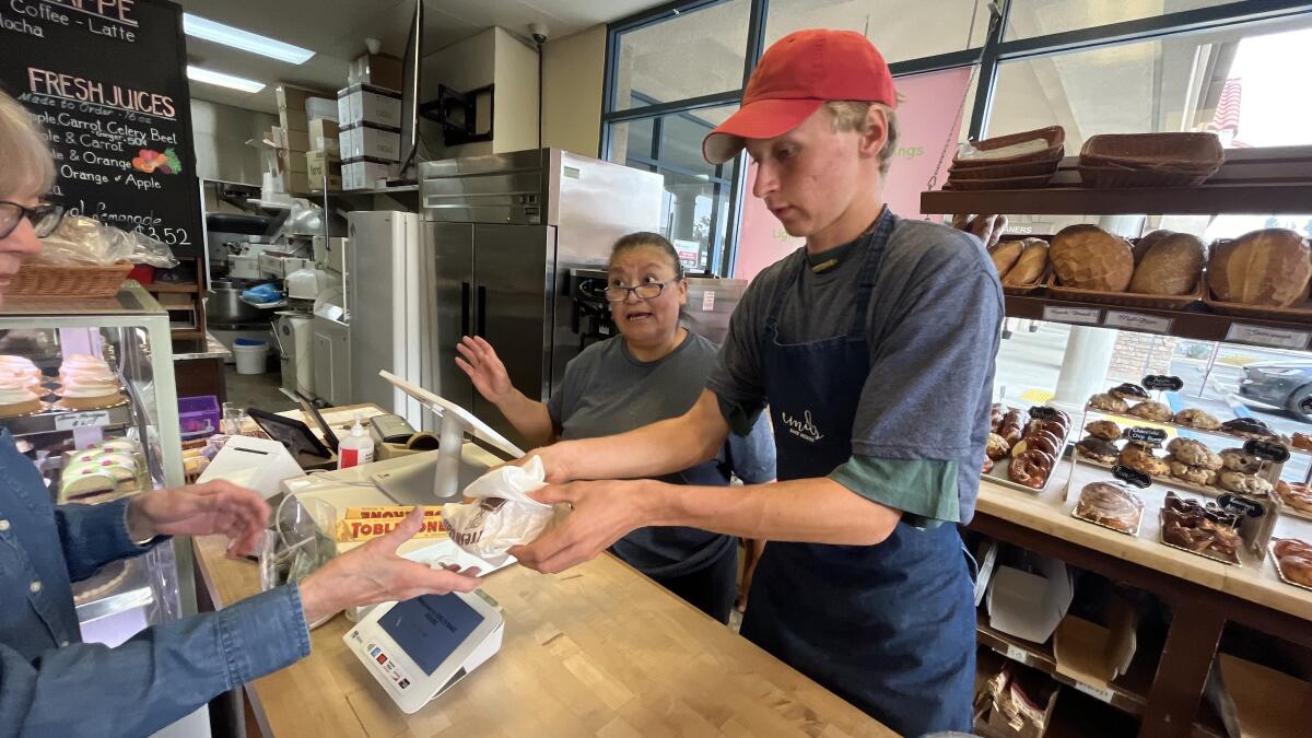 Patty Rivera, a barista at Emil's Bake House, center, recounts earthqauke at 7:28 Monday morning. 