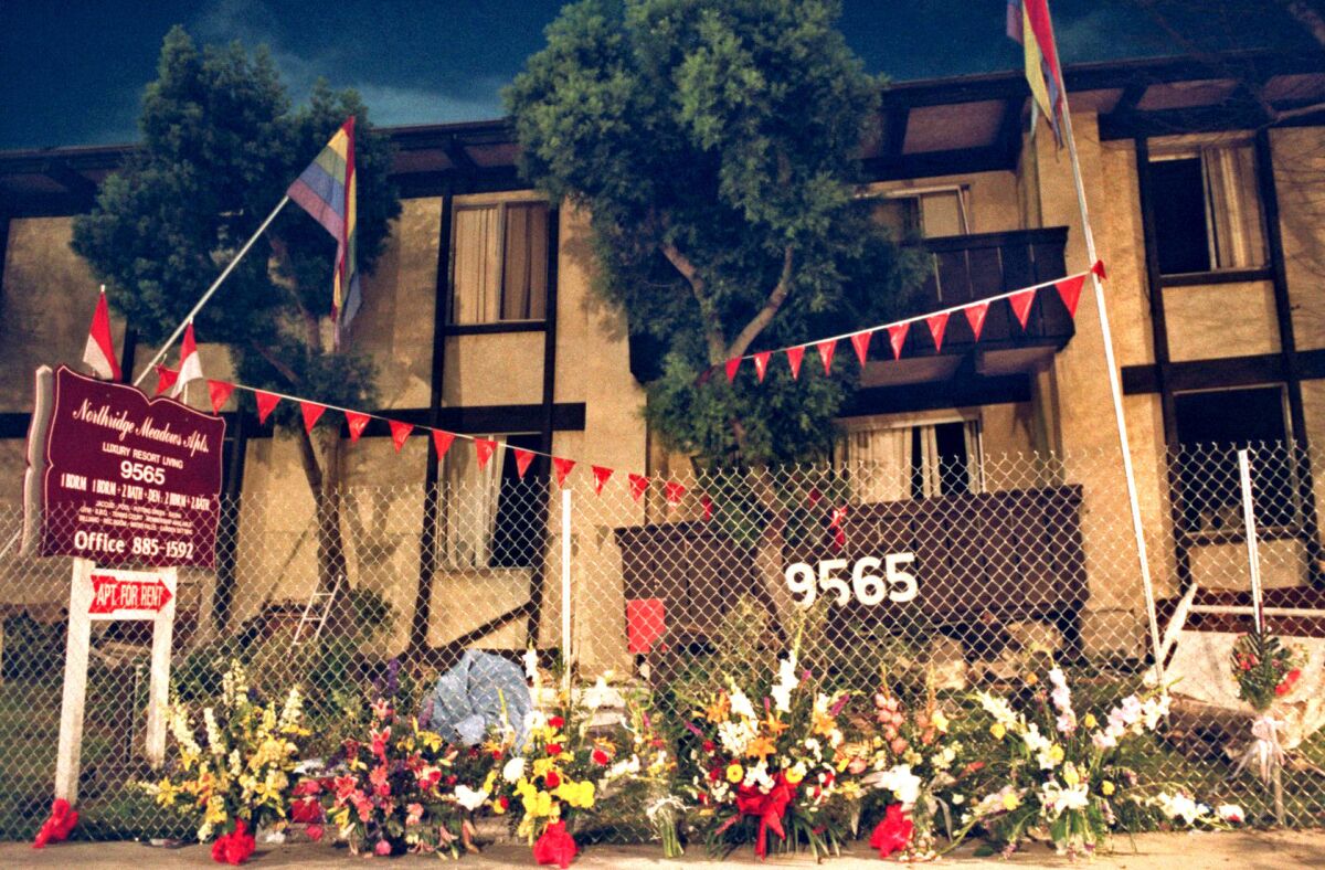 Flowers line a fence at the Northridge Meadows apartment complex a week after the Northridge earthquake.