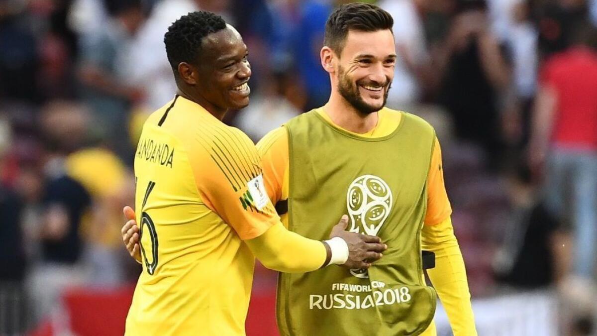 France backup goalkeeper Steve Mandanda, left, is congratulated by starting goalkeeper Hugo Lloris after a 0-0 draw against Denmark on Tuesday.
