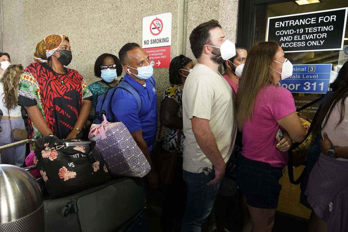 Passengers traveling overseas from Florida wait to get a coronavirus test.