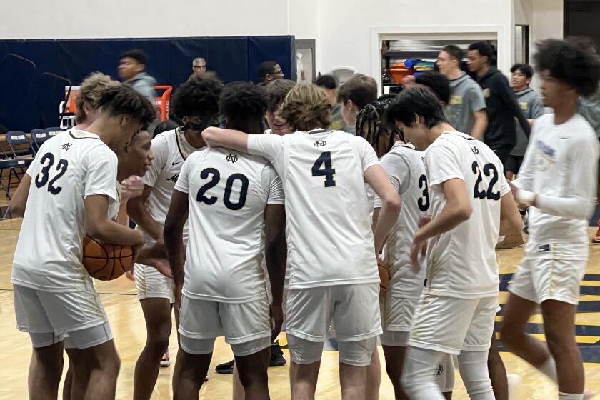 Sherman Oaks Notre Dame basketball players gather before their game against St. Francis. 