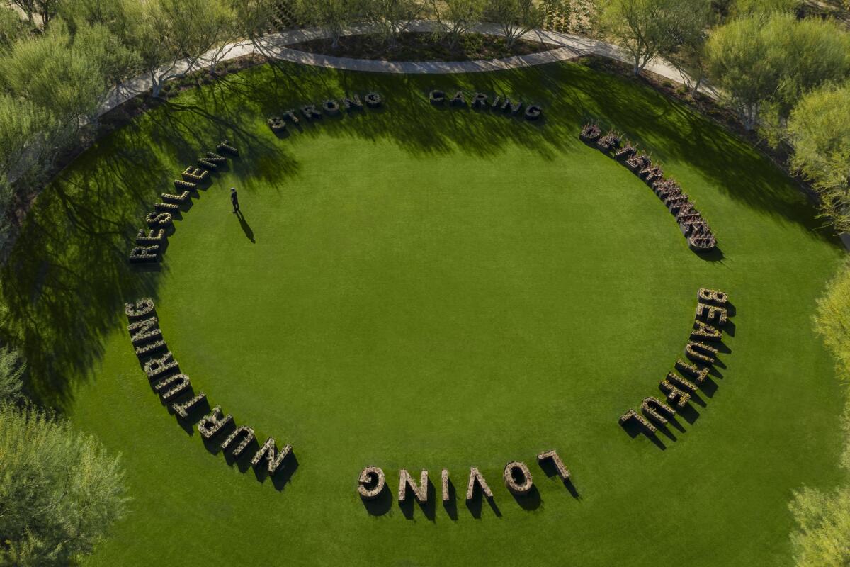 An aerial view of planters spelling out the words "loving," "beautiful," "nurturing," "resilient" and others.
