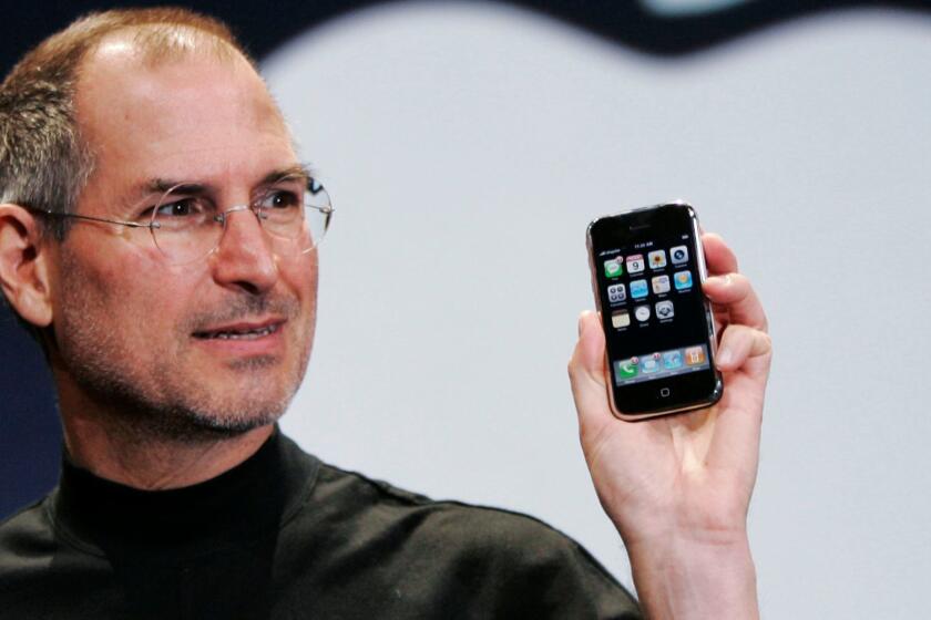 Steve Jobs, Apple's founder and late Chief Executive, holds up an iPhone at the 2007 MacWorld Conference in San Francisco.
