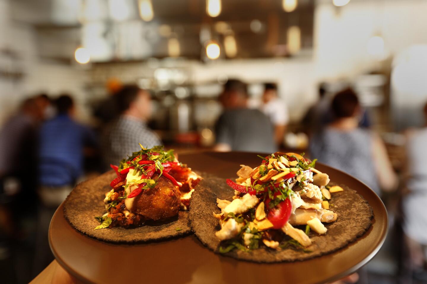 The tacos at Taco Maria are the stars, including Jardineros, left, and Mole de Pollo.