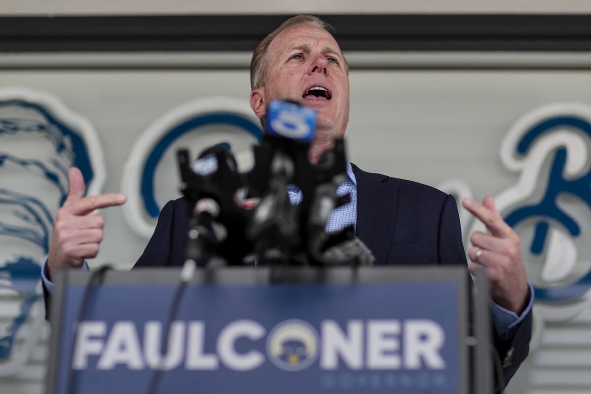 A man in front of a podium with microphones