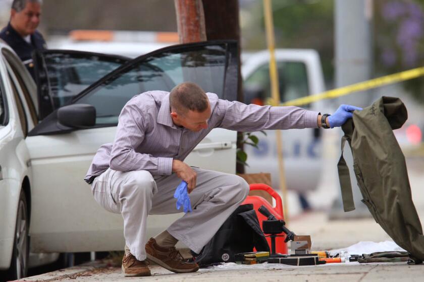 Authorities investigate the scene along 11th Street in Santa Monica, where a car was found with weapons, ammunition and other suspicious items.