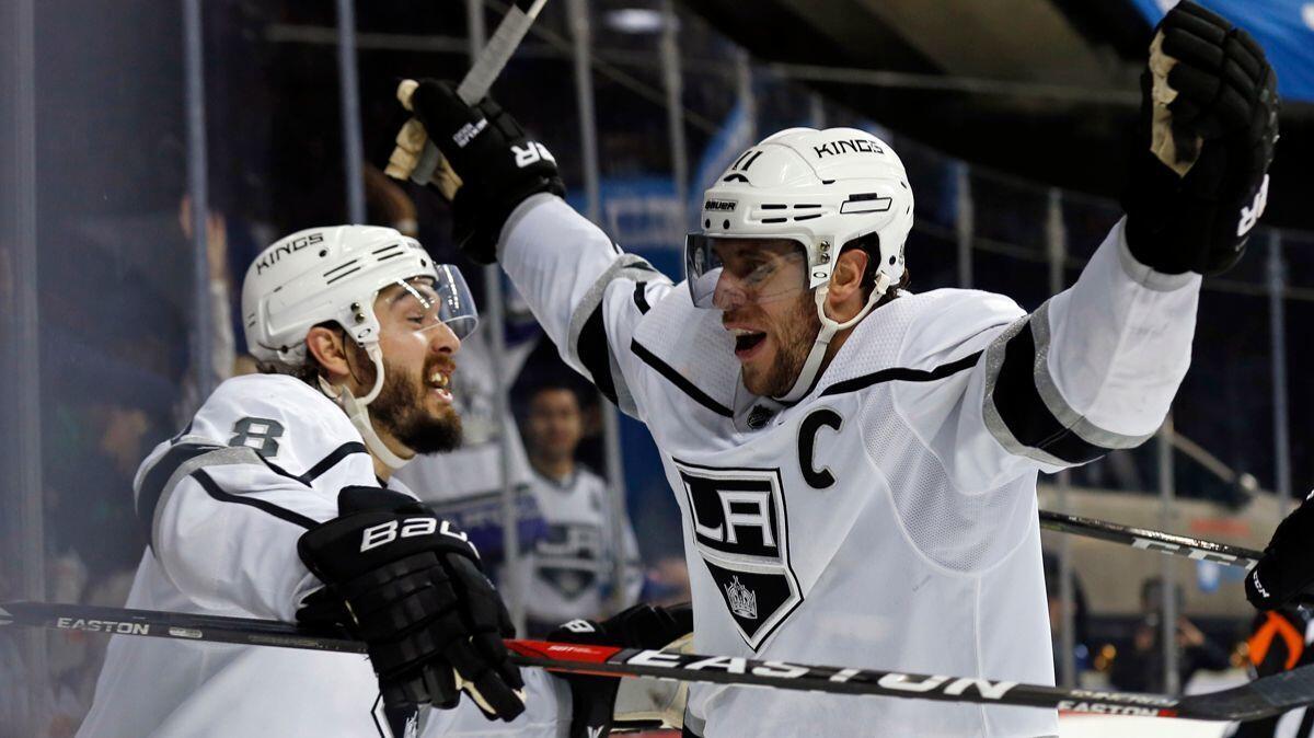 Kings center Anze Kopitar (11) celebrates scoring a goal with Kings defenseman Drew Doughty (8) against the New York Islanders in the third period on Dec. 16, 2017.