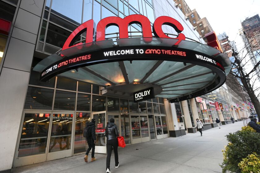 FILE - People walk by the AMC 34th Street theater on March 5, 2021, in New York. AMC Theaters, the nation's largest movie theater chain, on Monday unveiled a new pricing scheme in which seat location determines how much your movie ticket costs. Seats in the middle will cost a dollar or two more, while seats in the front row will be slightly cheaper. (Photo by Evan Agostini/Invision/AP, File)