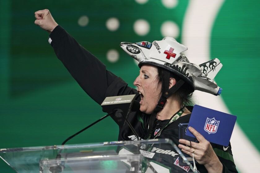 New York Jets fan of the year Lynne Pondview reacts after the Jets selected Michael Carter II, cornerback for Duke, in the fifth round of the NFL football draft, Saturday, May 1, 2021, in Cleveland. (AP Photo/Tony Dejak)