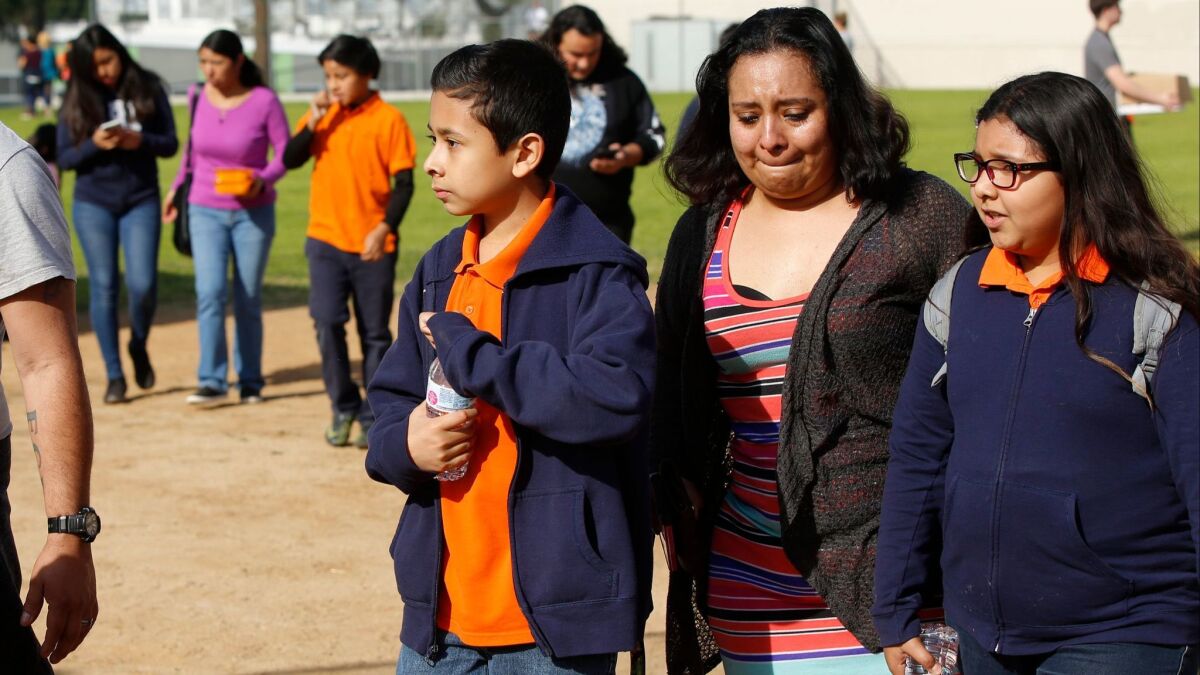 Parents reunite with their children after an accidental shooting at Salvador B. Castro Middle School in Los Angeles on Feb. 1.