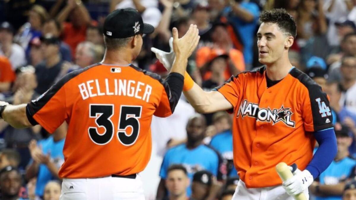 Dodgers rookie Cody Bellinger, right, is congratulated by his father, Clay.