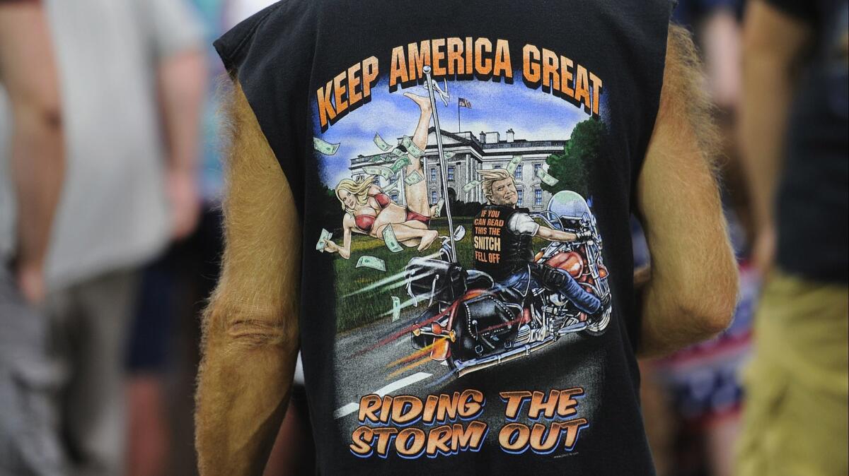 An attendee wears a shirt depicting President Trump and adult entertainment star Stormy Daniels at a campaign rally at the Ford Center on Aug. 30 in Evansville, Ind.
