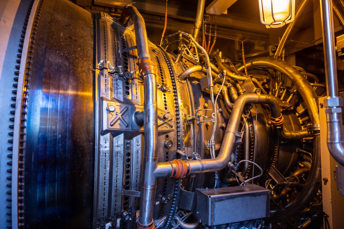 A large piece of metal machinery with numerous pipes and wires.