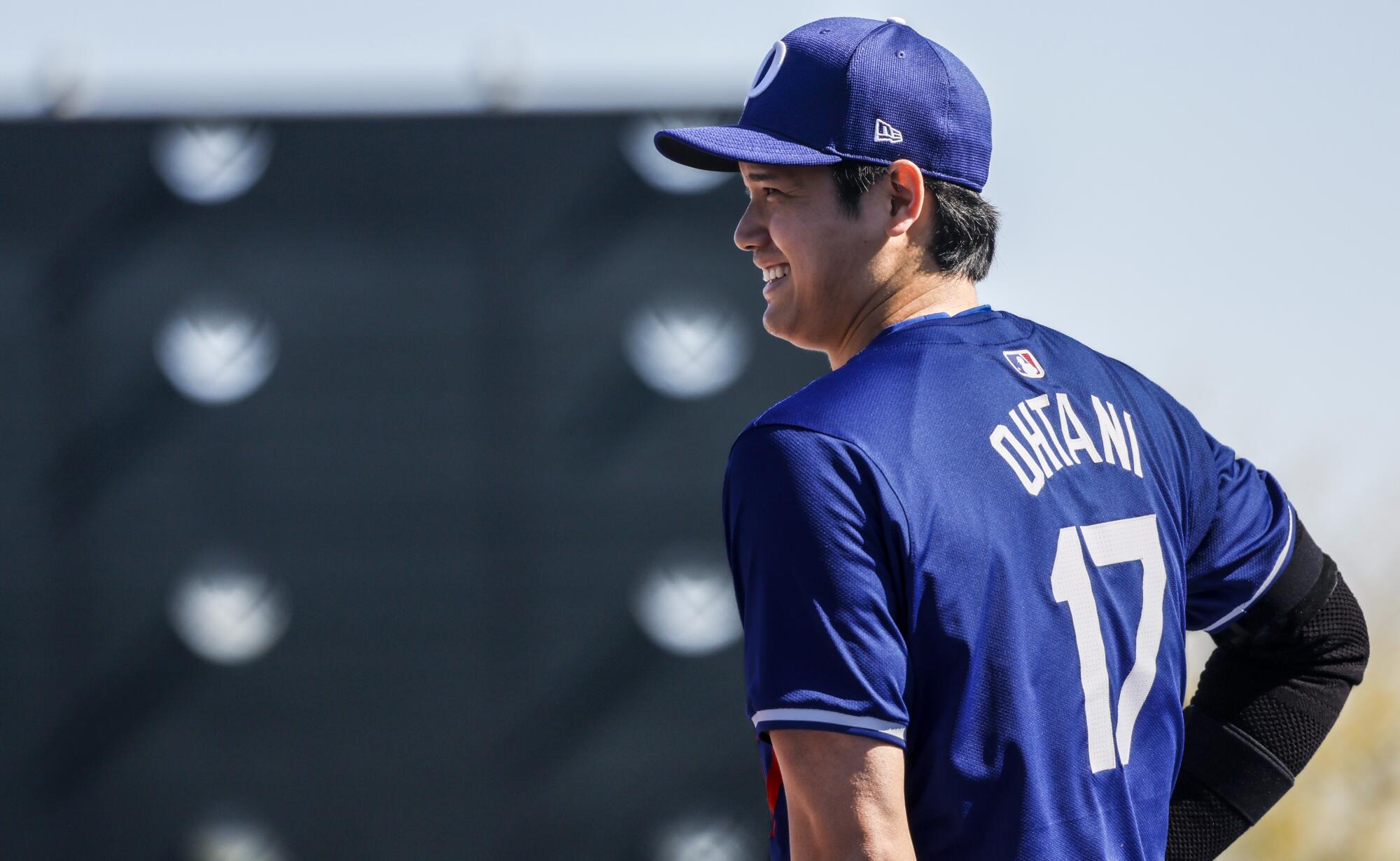 Shohei Ohtani stands on the field during spring training workouts at Camelback Ranch in February.