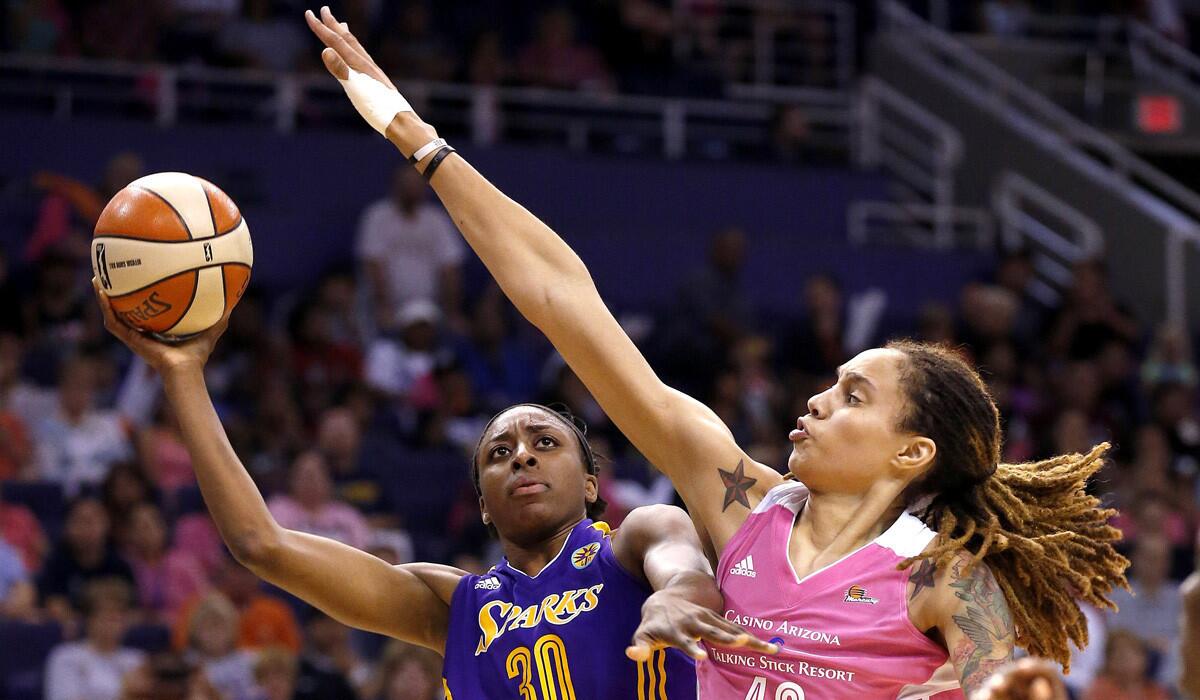 Phoenix Mercury's Brittney Griner tries to block the shot of Los Angeles Sparks' Nneka Ogwumike during the second half of a game in Phoenix on July 29, 2014.