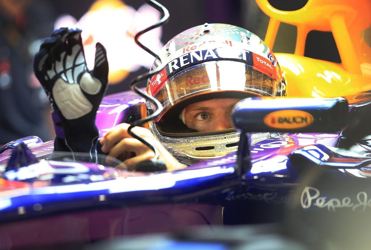 Sebastian Vettel prepares to drive out of his team garage during Friday's practice session for the Singapore Grand Prix on the Marina Bay City Circuit.