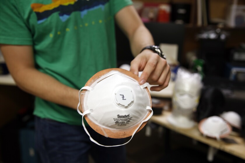 Albert Nazeeri holds an N95 respirator