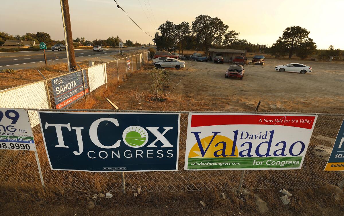 Political signs for congressional challengers T.J. Cox and David Valadao along Highway 43 in Selma, Calif.