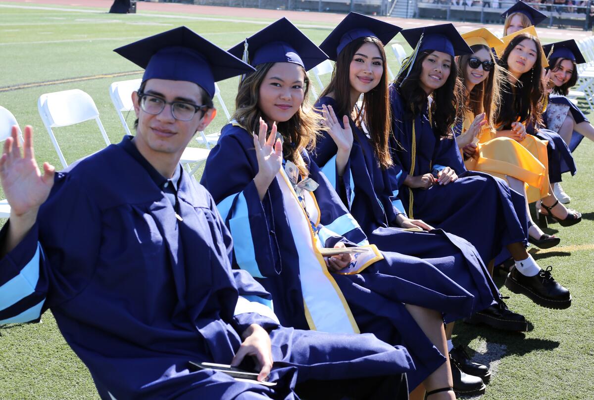 Marina High School graduates wave to their family and friends during Thursday's commencement ceremony.