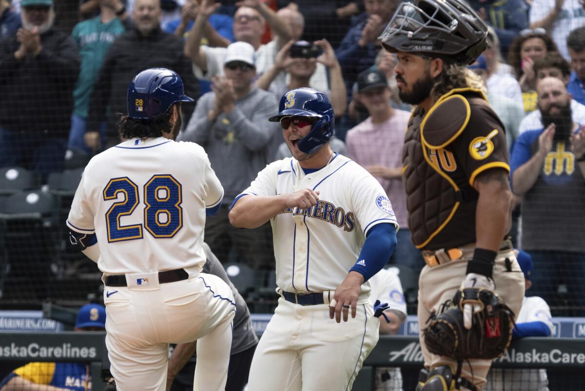 Eugenio Suarez, left, is congratulated by Ty France after hitting a two-run home run off Padres starter Mike Clevinger.