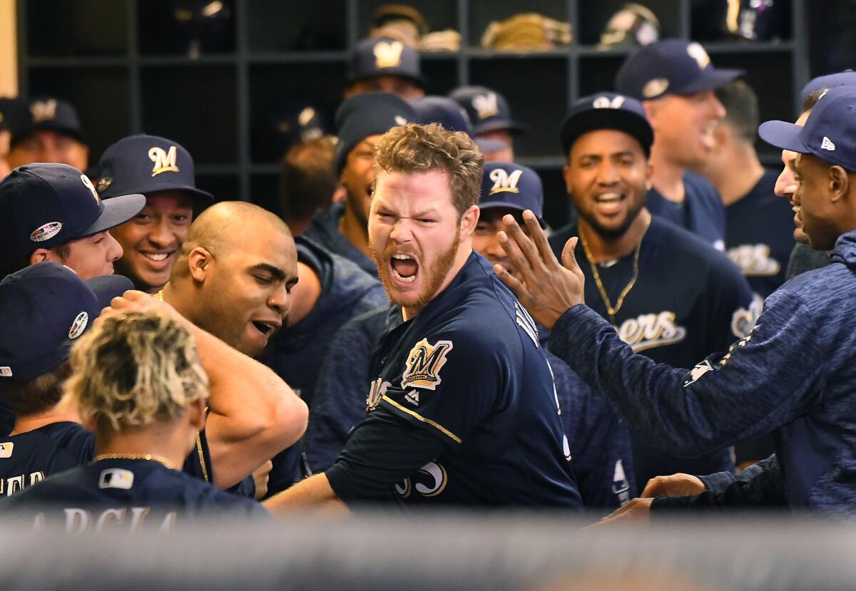 Milwaukee Brewers pitcher Brandon Woodruff celebrates his solo home run against the Dodgers in Game 1 of the NLCS at Miller Park in Milwaukee on Friday.