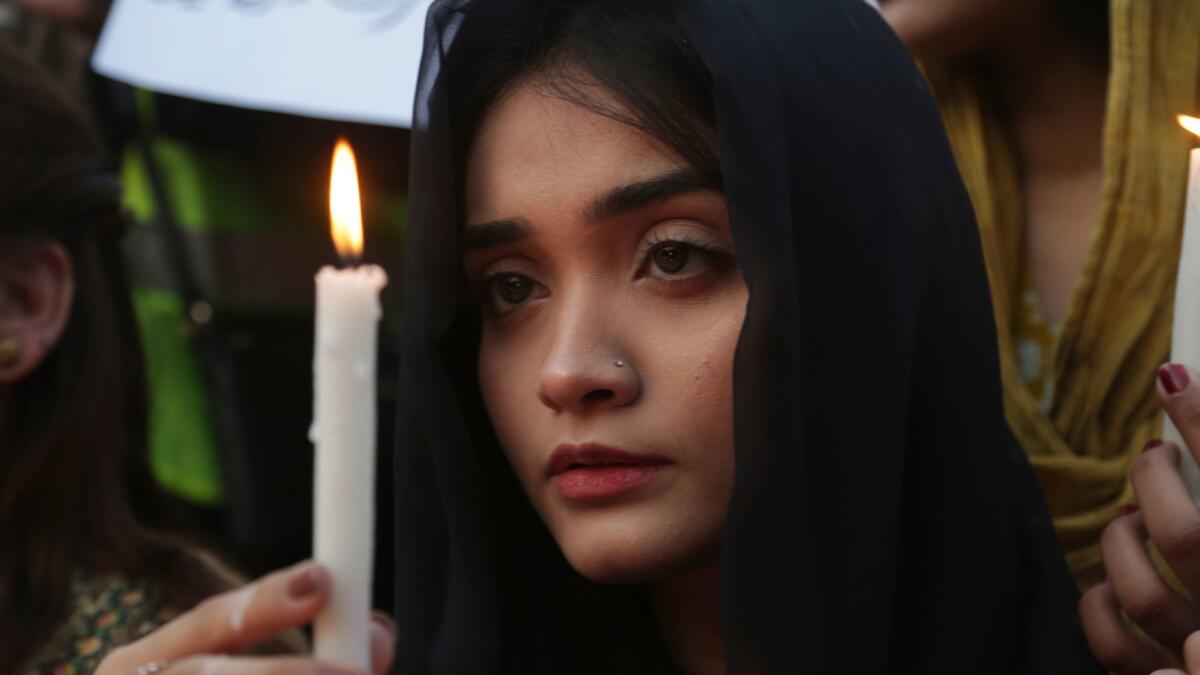 A Pakistani girl joins others at a memorial in Lahore for Zainab Ansari, who was raped and killed.