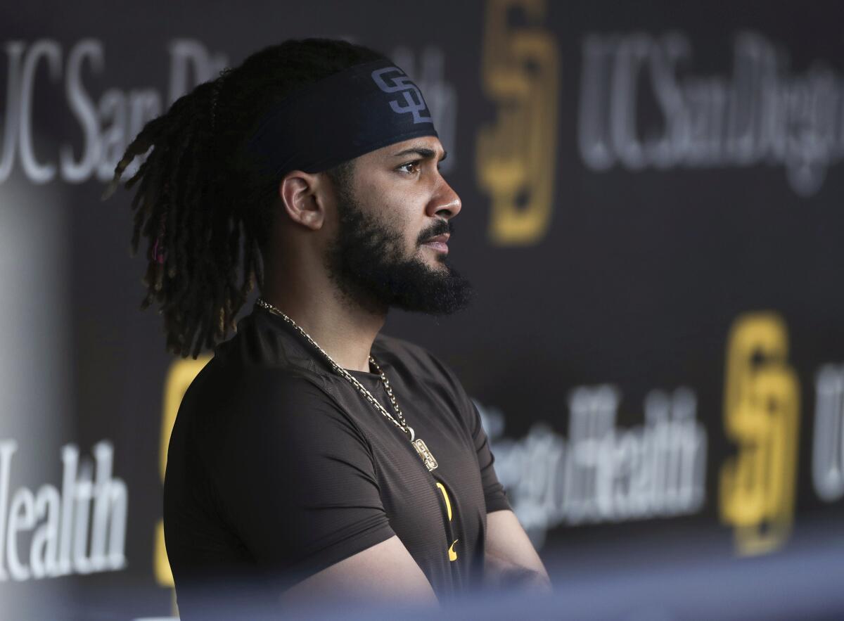 Padres star Fernando Tatis Jr. looks out from the dugout before a game against the Phillies in June.