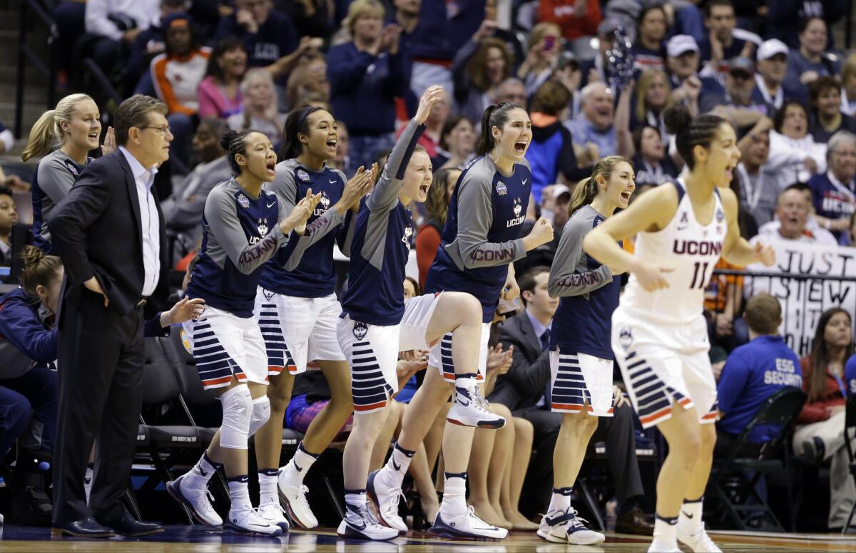 The Connecticut bench celebrates during the second half of the Huskies' 82-51 victory over the Syracuse Orange in the NCAA championship game on April 5.