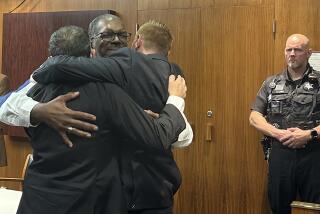 Three security guards hug after a jury found them not guilty of involuntary manslaughter in a man's death at a Detroit-area mall more than 10 years ago, Friday, Aug. 23, 2024. (AP Photo/EJ White)