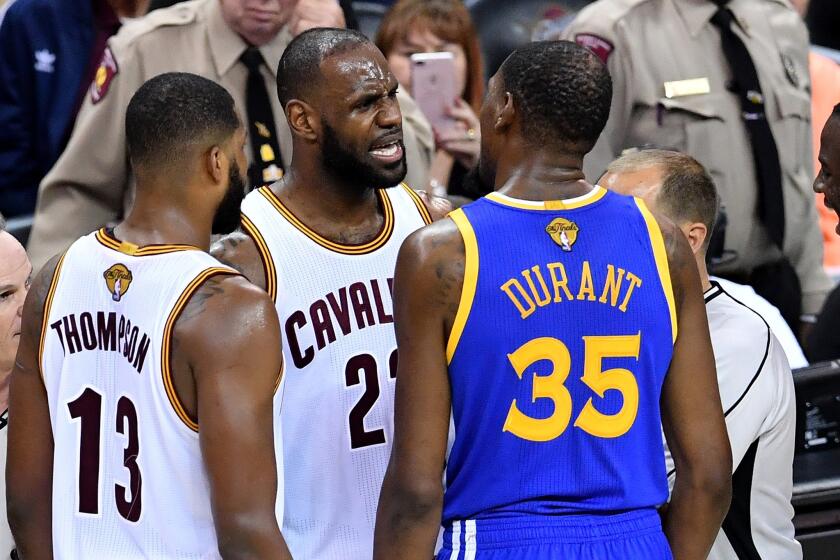 Cavaliers forward LeBron James and Warriors forward Kevin Durant exchange words after a foul call during the second half.