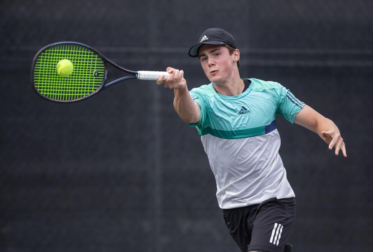 Daniel Day of Laguna Beach returns a shot to Joseph Emerson of Whittier in the boys' 18-and-under round of 64 singles match at the 117th USTA Southern California Junior Sectional Championships at Los Caballeros Sports Village in Fountain Valley on Wednesday.