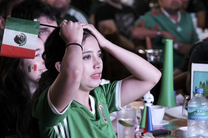 Mexico soccer fan Monse Maldonado reacts after Brazil scored during the World Cup match between Mexico and Brazil, at Guelaguetza Restaurante in Los Angeles on Monday, July 2, 2018. Neymar flaunted his flair and theatrics with a goal and an assist to Brazil into the quarterfinals at the World Cup in a 2-0 victory that sent Mexico home in the round of 16 yet again. (AP Photo/Richard Vogel)