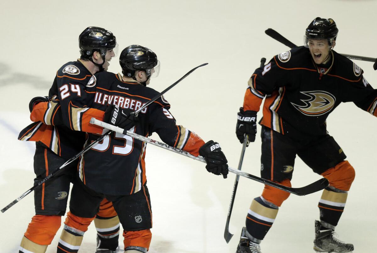 Jakob Silfverberg is congratulated by Ducks teammates Simon Despres (24) and Cam Fowler (4) after scoring the game-winning goal with 19 seconds left in Game 2 against the Jets.
