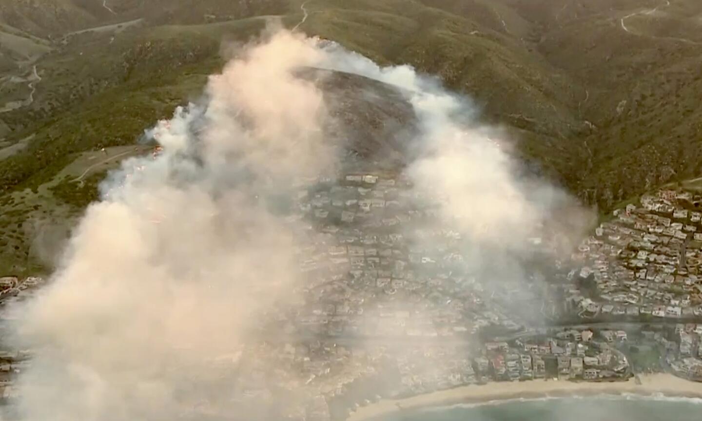A brush fire is threatening homes near Irvine Cove in Laguna Beach.