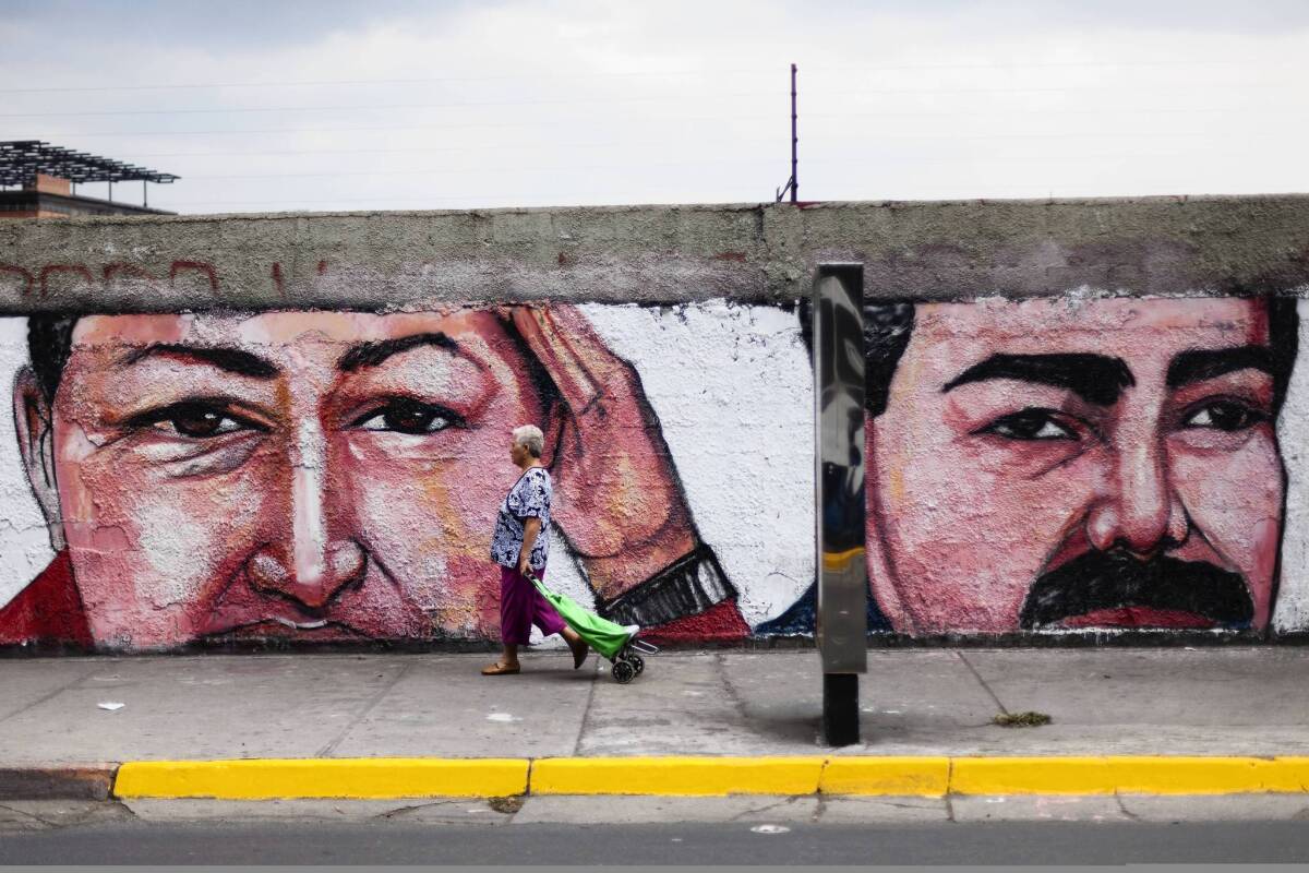 A mural in Caracas depicts late Venezuelan President Hugo Chavez, left, and his anointed successor, new President Nicolas Maduro.