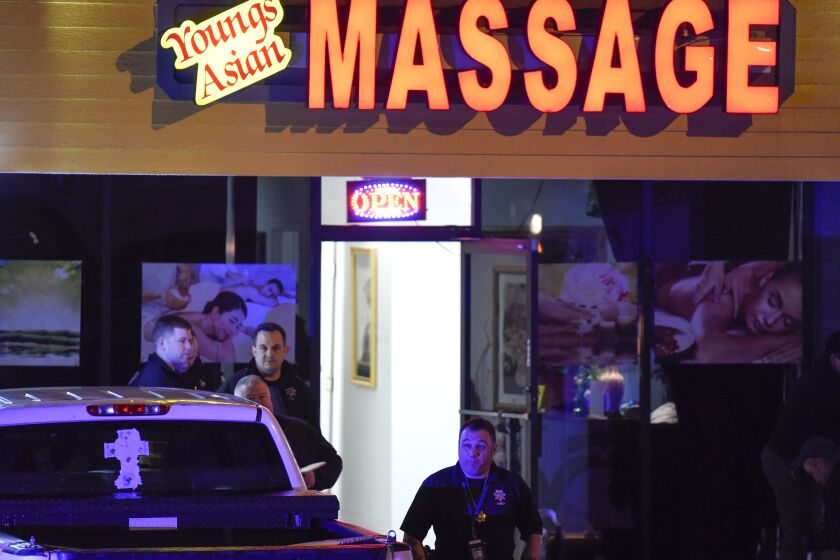 Authorities investigate a fatal shooting at a massage parlor, late Tuesday, March 16, 2021, in Woodstock, Ga. Officials say 21-year-old Robert Aaron Long, of Woodstock, Georgia, has been captured hours after multiple people were killed in shootings at three Atlanta-area massage parlors. (AP Photo/Mike Stewart)