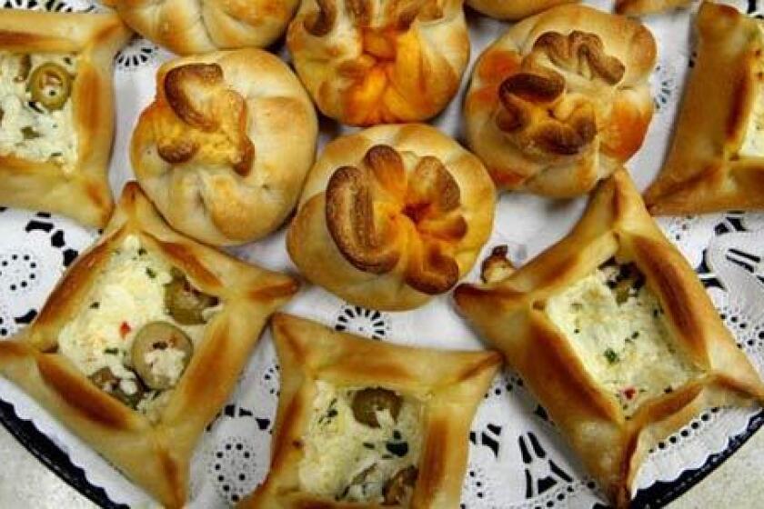 Potato Mushroom Puffs (round) and olive cheese bureks (square) are for sale at the Zaatar Factory and Bakery.